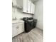 Well-equipped laundry room with modern washer and dryer and functional storage at 8630 Sw 61St Loop, Ocala, FL 34481