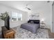 Serene main bedroom features a ceiling fan, large window, modern decor and a comfortable bed at 8630 Sw 61St Loop, Ocala, FL 34481