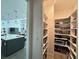 Well-organized pantry with white shelves and visible kitchen at 8630 Sw 61St Loop, Ocala, FL 34481