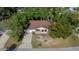 Aerial view of a single-Gathering home with a two-car garage, a concrete driveway, and landscaping in the front yard at 8639 Sw 116Th Lane Rd, Ocala, FL 34481