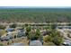 Aerial view of a residential community surrounded by lush greenery and backing up to a beautiful forest at 8639 Sw 116Th Lane Rd, Ocala, FL 34481