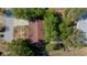 Aerial view of a single-Gathering home with a red roof, surrounded by lush trees and a driveway leading to the street at 8639 Sw 116Th Lane Rd, Ocala, FL 34481