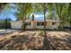 Home's backyard featuring a charming chimney, patio, and partially fenced perimeter at 8639 Sw 116Th Lane Rd, Ocala, FL 34481