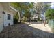 A nice backyard that includes a large stone patio area with mature trees providing plenty of shade at 8639 Sw 116Th Lane Rd, Ocala, FL 34481