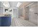 Bathroom with double sinks, white tile floor, shower and bathtub at 8639 Sw 116Th Lane Rd, Ocala, FL 34481
