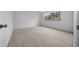 Spacious carpeted bedroom features a large window and neutral walls at 8639 Sw 116Th Lane Rd, Ocala, FL 34481
