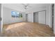 A well-lit bedroom with a large window, wood-look floors, and spacious closets at 8639 Sw 116Th Lane Rd, Ocala, FL 34481