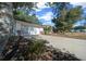 A single-Gathering home showcasing the garage, a driveway, and mature landscaping at 8639 Sw 116Th Lane Rd, Ocala, FL 34481