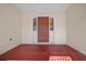 A welcoming front porch featuring a red front door and exterior matching trim at 8639 Sw 116Th Lane Rd, Ocala, FL 34481