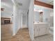 A hallway view of a bathroom on the right and living area with a fireplace on the left at 8639 Sw 116Th Lane Rd, Ocala, FL 34481