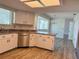 Bright kitchen featuring white cabinets, stainless steel dishwasher, and a view of the dining area at 8639 Sw 116Th Lane Rd, Ocala, FL 34481