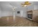 Living room featuring wood-look floors and a brick fireplace at 8639 Sw 116Th Lane Rd, Ocala, FL 34481