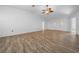 Bright living room with neutral walls, wood-look tile flooring, and a ceiling fan at 8639 Sw 116Th Lane Rd, Ocala, FL 34481