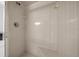 All-white tiled shower with built-in bench and shower niche at 8639 Sw 116Th Lane Rd, Ocala, FL 34481