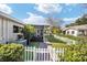 Charming backyard featuring a screened-in patio, artificial turf, and a classic white picket fence at 8707 Sw 95Th Ln # G, Ocala, FL 34481