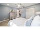 Bright bedroom with light blue walls, laminate flooring, and closet space at 8707 Sw 95Th Ln # G, Ocala, FL 34481