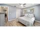 Cozy bedroom featuring light blue walls, laminate flooring, and closet space at 8707 Sw 95Th Ln # G, Ocala, FL 34481