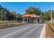 A view of the secured entry gate to the community featuring colorful landscaping at 8707 Sw 95Th Ln # G, Ocala, FL 34481