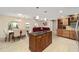 View of kitchen island, dining and living room area with lots of natural light and open floorplan at 8707 Sw 95Th Ln # G, Ocala, FL 34481