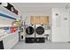 A laundry room inside the garage features a modern washer and dryer and a utility sink at 8707 Sw 95Th Ln # G, Ocala, FL 34481