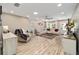 Bright living room features wood floors, a white sofa, chair, and plenty of natural light at 8707 Sw 95Th Ln # G, Ocala, FL 34481