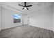 Bedroom with ceiling fan and large window at 9731 Bahia Rd, Ocala, FL 34472