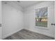 Bright closet featuring a window, wire shelving, and gray flooring at 9731 Bahia Rd, Ocala, FL 34472