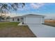 Newly built home with gray exterior, two-car garage, and landscaped lawn at 9731 Bahia Rd, Ocala, FL 34472