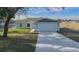 Newly built home with gray siding and a paved driveway at 9731 Bahia Rd, Ocala, FL 34472