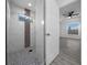 Walk-in shower with marble tile and glass enclosure at 9731 Bahia Rd, Ocala, FL 34472