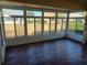 Bright sunroom with wood-look flooring and ample natural light at 9761 Sw 90Th St, Ocala, FL 34481