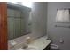 This bathroom features a toilet, a bath tub, and a marble countertop sink at 10015 Sw 90Th Ct, Ocala, FL 34481