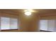 Bedroom with a fan and light fixture, window with white blinds and curtains at 10015 Sw 90Th Ct, Ocala, FL 34481