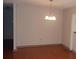 Comfortable dining area with hardwood floors and classic chandelier lighting at 10015 Sw 90Th Ct, Ocala, FL 34481