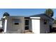 Back view of this home showcasing the side door and a window air conditioning unit at 10015 Sw 90Th Ct, Ocala, FL 34481
