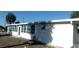 Side view of this charming home highlighting the window-lined side of the house at 10015 Sw 90Th Ct, Ocala, FL 34481
