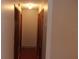 Hallway featuring neutral walls, wood trim and doors to bedrooms and bathrooms at 10015 Sw 90Th Ct, Ocala, FL 34481