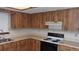 Practical kitchen design with wood cabinets and standard appliances at 10015 Sw 90Th Ct, Ocala, FL 34481