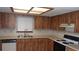 Functional kitchen equipped with wood cabinets and essential appliances at 10015 Sw 90Th Ct, Ocala, FL 34481