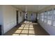 This outdoor patio has a covered ceiling, and multiple windows along the side at 10015 Sw 90Th Ct, Ocala, FL 34481