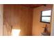 This storage room has wood paneling, a window, and a ladder on the side at 10015 Sw 90Th Ct, Ocala, FL 34481
