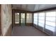 This is a sunroom with carpet floors, wood paneling, and windows at 10015 Sw 90Th Ct, Ocala, FL 34481