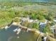 Overhead view of waterfront homes with docks, and lush landscape at 10900 Se Timucuan Rd, Summerfield, FL 34491