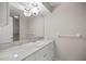 Bathroom with a marble countertop, white cabinets, and modern fixtures at 10900 Se Timucuan Rd, Summerfield, FL 34491