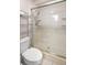 Clean bathroom featuring tiled shower with glass doors, new fixtures, and toilet at 10900 Se Timucuan Rd, Summerfield, FL 34491