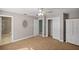 Open bedroom with a neutral color scheme, en suite bath and an entrance to another room at 10900 Se Timucuan Rd, Summerfield, FL 34491