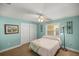 Bright bedroom with a ceiling fan, and a comfortable bed with a patterned blanket at 10900 Se Timucuan Rd, Summerfield, FL 34491