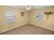 Inviting bedroom with a ceiling fan, two windows and soft carpet at 10900 Se Timucuan Rd, Summerfield, FL 34491