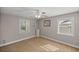 Cozy bedroom with neutral walls, two windows letting in natural light, and soft carpet at 10900 Se Timucuan Rd, Summerfield, FL 34491