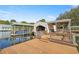 Beautiful boathouse, dock and boat lift on the water with spacious deck and room for entertaining at 10900 Se Timucuan Rd, Summerfield, FL 34491